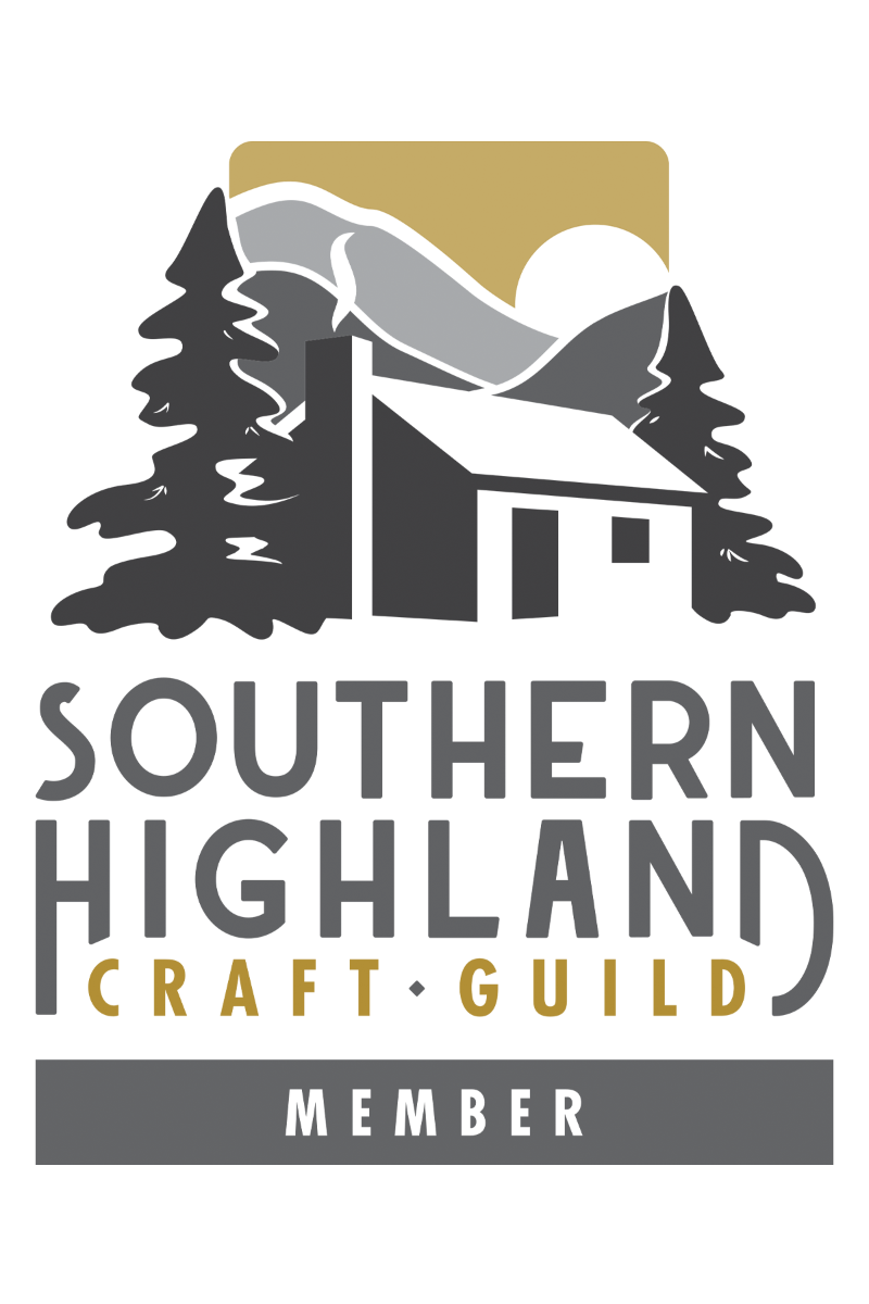Logo of the Southern Highland Craft Guild with a house and mountain silhouette.